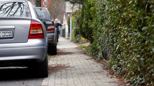 Autos parken teilweise auf einem Gehweg