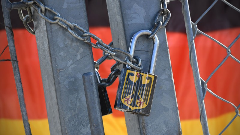 A lock with a federal eagle closes a gate.