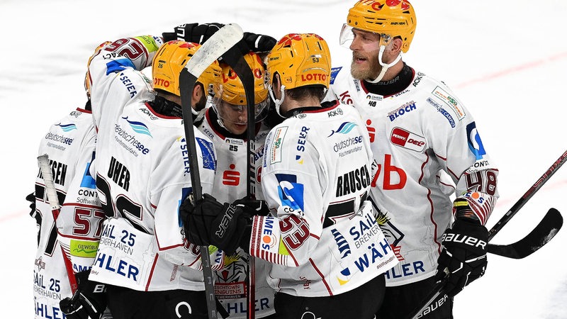 Eishockey-Spieler der Fischtown Pinguins kommen zum Torjubel zusammen.