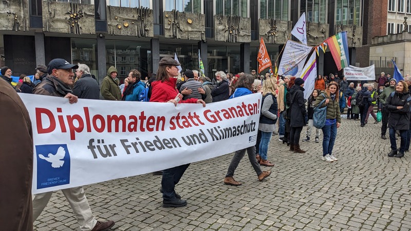 People hold a banner in the marketplace on the 