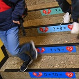 Grundschüler gehen auf einer Flurtreppe in die Pause (Symbolbild)