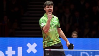 Werders Tischtennis-Profi Andrej Putuntica bejubelt mit hochgereckter Faust einen Punktgewinn gegen Timo Boll.