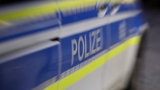 Ein Polizeiauto ist unscharf zu erkennen.